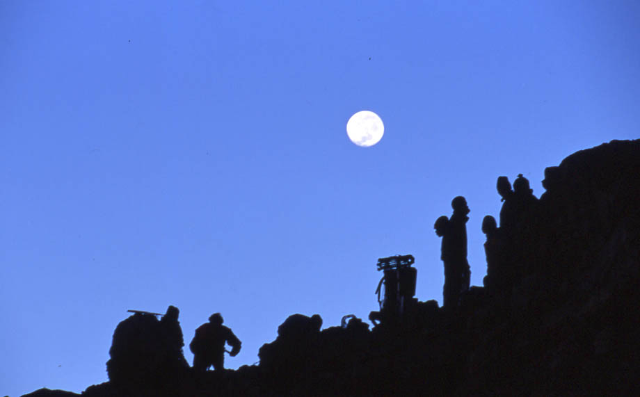 Tanzania Mount Kilimanjaro, Climbing Kilimanjaro Summit, Porters and Film Crew - waiting for 1st light at Arrow Glacier Camp (15,500ft). Hoping to beat the mists, Walkopedia