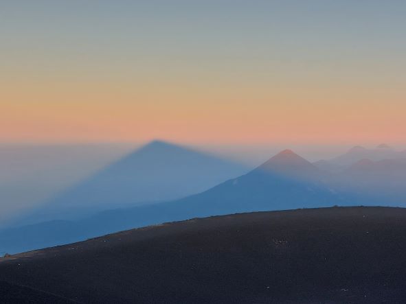 Volcan Acatenango and Volcan Fuego: Acatenango dawn shadow - © William Mackesy...